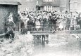 Spectators standing on the bridge over the Henmore in Dig Street - Note the Coach & Horses in the background